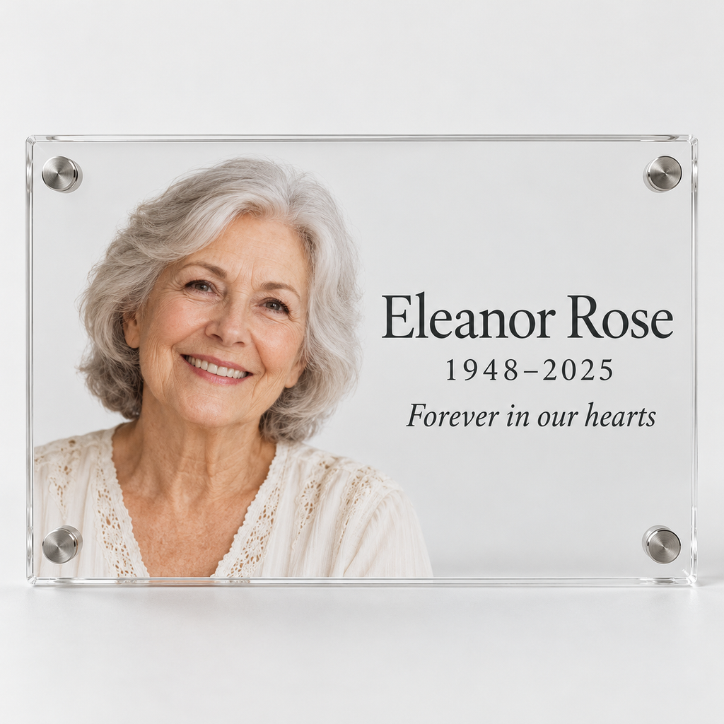 Custom acrylic memorial photo plaque with a portrait, the name Eleanor Rose, dates 1948–2025 and the words Forever in our hearts, on clear acrylic with silver standoffs