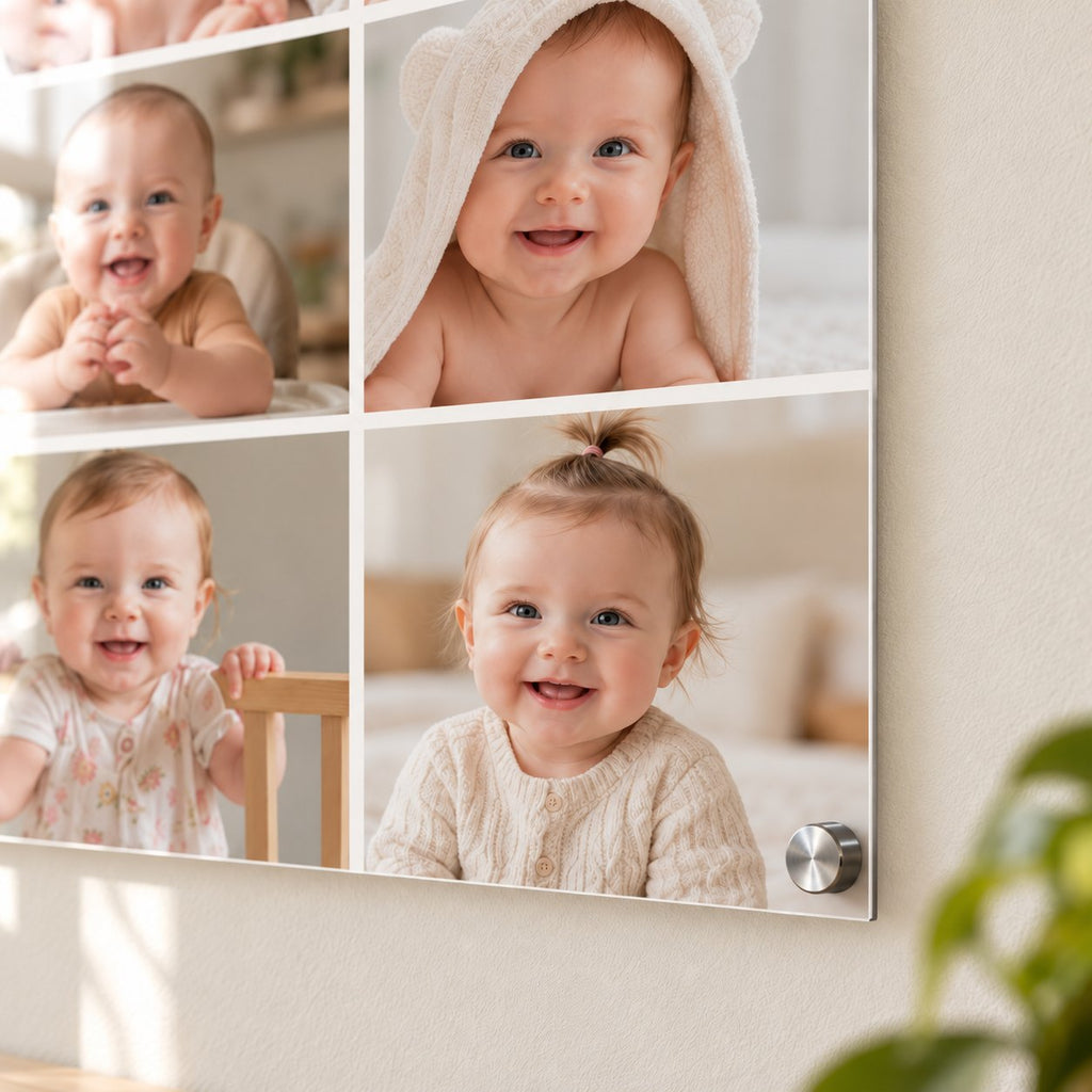 Close-up of a baby photo collage printed on thin clear acrylic, showing four monthly baby photos and a brushed silver standoff