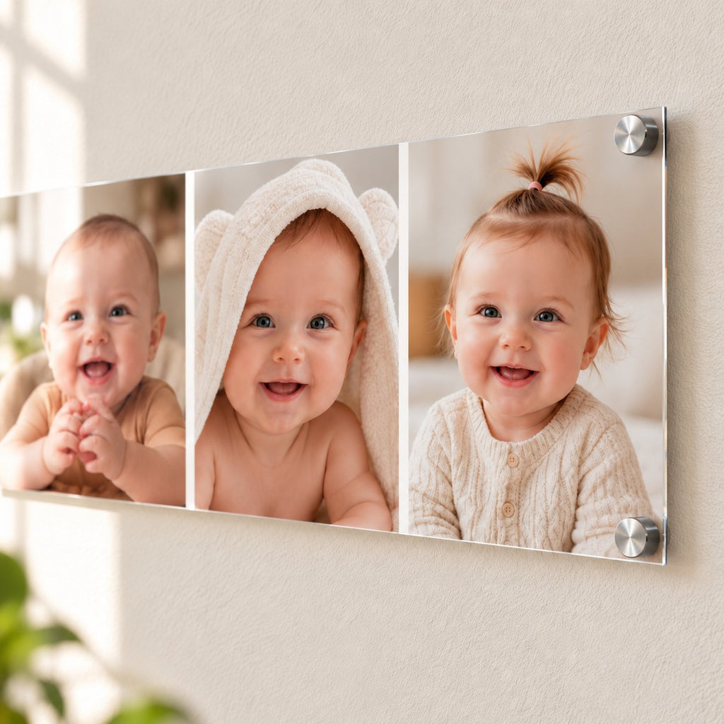 Three baby photos side by side on one long clear acrylic print mounted with silver standoffs