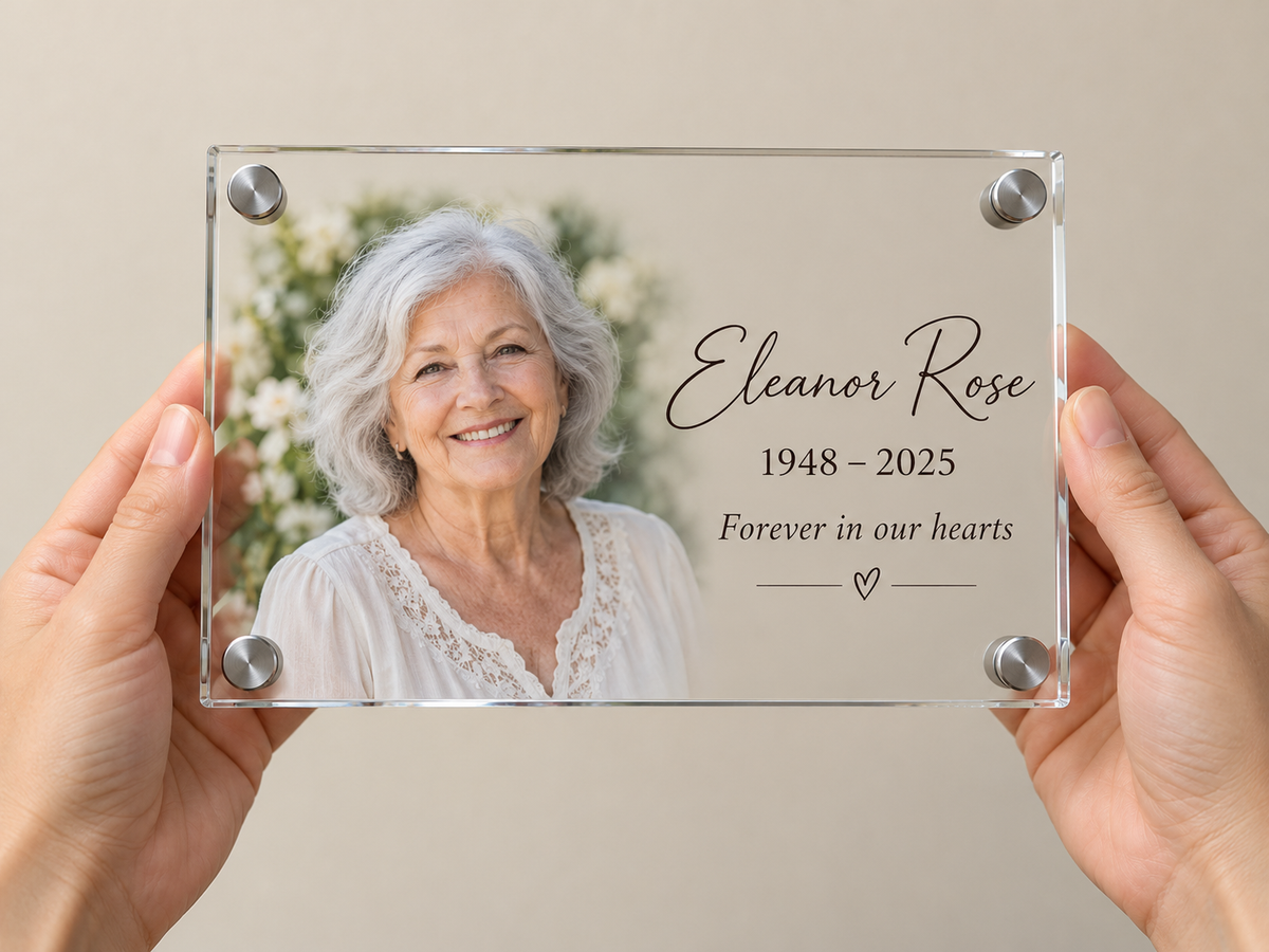 Small 10 x 8 inch acrylic photo plaque held in two hands to show its size, with a portrait, the name Eleanor Rose in script lettering, dates and a short message