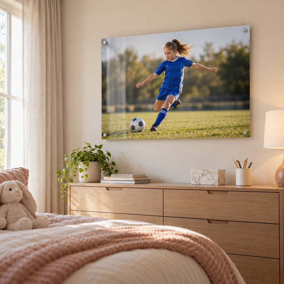 Action photo of a young soccer player kicking a ball, printed on clear acrylic in a bedroom